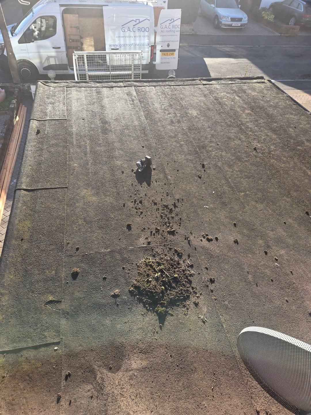 Failing felt roof with debris