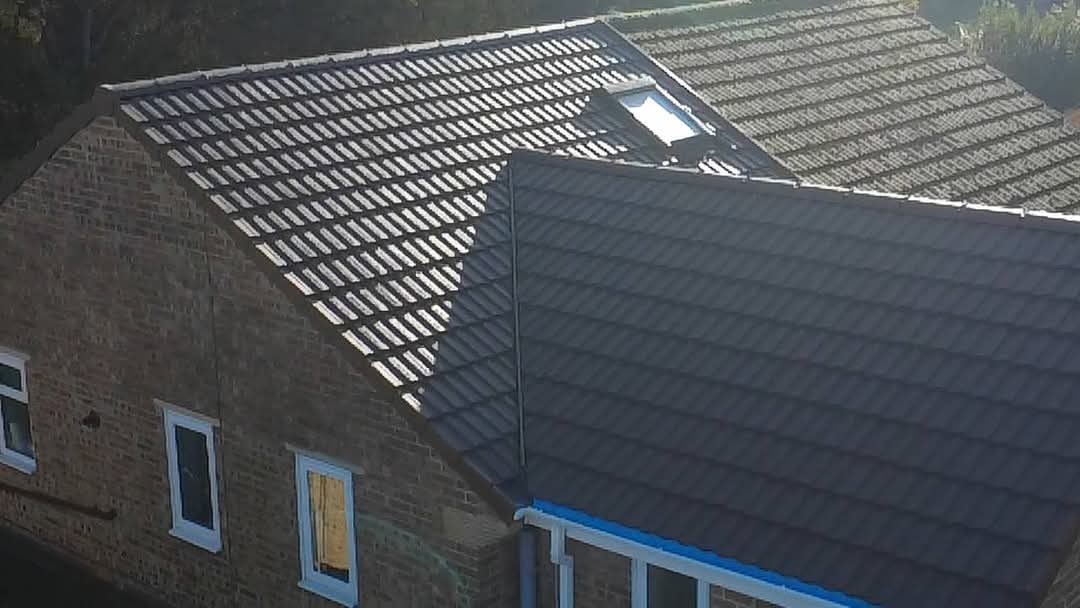 New tiled roof with hips and ridges